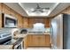 Well-lit kitchen featuring stainless steel appliances and light wood cabinets, offering a functional cooking space at 1430 57Th W St # 1430, Bradenton, FL 34209