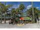 Unique waterfront restaurant sign surrounded by lush tropical greenery with blue skies at 146 Willow Bend Way, Osprey, FL 34229