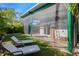 Landscaped backyard with two lounge chairs and a screened outdoor area for relaxing at 2254 Hawthorne St, Sarasota, FL 34239