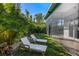 Private backyard featuring lush landscaping, lounge chairs, and relaxing outdoor space at 2254 Hawthorne St, Sarasota, FL 34239