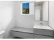 Modern bathroom featuring vanity with sleek countertop, mirror, and window to let in natural light at 2254 Hawthorne St, Sarasota, FL 34239