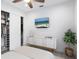Well-lit bedroom with TV, white dresser, and organized closet space at 2254 Hawthorne St, Sarasota, FL 34239