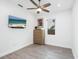Bright bedroom with a ceiling fan, light wood dresser, and a beach scene on the television at 2254 Hawthorne St, Sarasota, FL 34239
