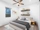 Bright bedroom featuring a ceiling fan, floating shelves, and neutral decor at 2254 Hawthorne St, Sarasota, FL 34239