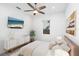 Cozy bedroom featuring a ceiling fan, TV, and white and gold accents at 2254 Hawthorne St, Sarasota, FL 34239