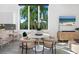 Bright breakfast nook featuring a round table, stylish chairs, and a view of tropical foliage at 2254 Hawthorne St, Sarasota, FL 34239