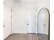 Hallway with neutral walls, modern mirror, and wood-look tile flooring at 2254 Hawthorne St, Sarasota, FL 34239