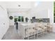 Modern kitchen with white cabinets, large island, and stylish backsplash, perfect for cooking and entertaining at 2254 Hawthorne St, Sarasota, FL 34239
