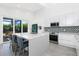 Bright open kitchen with sleek cabinets, stainless steel appliances, and island with bar seating at 2254 Hawthorne St, Sarasota, FL 34239
