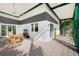 Spacious patio with dining set, TV, and view of the beautiful landscaped backyard at 2254 Hawthorne St, Sarasota, FL 34239