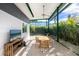 Inviting screened outdoor patio with ceiling fan, dining table, and backyard views at 2254 Hawthorne St, Sarasota, FL 34239