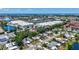 Expansive aerial view of a residential neighborhood with lush greenery and a glimpse of the ocean in the distance at 2321 Terry Ln, Sarasota, FL 34231