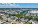 Wide aerial view showing houses near a blue water tower and pond, nestled among trees and streets in a sunny neighborhood at 2321 Terry Ln, Sarasota, FL 34231