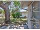 Inviting backyard featuring a mature tree and access to the home's interior at 2321 Terry Ln, Sarasota, FL 34231