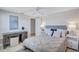 Bright bedroom with ceiling fan, desk, and bed with decorative pillows at 2321 Terry Ln, Sarasota, FL 34231