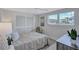 Cozy bedroom with bright window, neutral walls, and closet with sliding doors at 2321 Terry Ln, Sarasota, FL 34231
