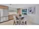 Bright dining area featuring a rustic table setting, modern decor, and ample natural light at 2321 Terry Ln, Sarasota, FL 34231