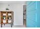 Bright entryway showcasing a stylish wood cabinet, decorative baskets, and a glimpse into the home's interior at 2321 Terry Ln, Sarasota, FL 34231