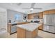 Spacious kitchen featuring stainless steel appliances, ample cabinet space, and a functional island perfect for cooking at 2321 Terry Ln, Sarasota, FL 34231