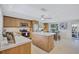 Modern kitchen with stainless steel appliances, light wood cabinetry, and a central island for meal prep and entertaining at 2321 Terry Ln, Sarasota, FL 34231