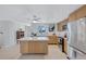 Bright and airy kitchen with stainless steel appliances, light wood cabinets, and a central island for food preparation at 2321 Terry Ln, Sarasota, FL 34231