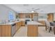 Well-lit kitchen featuring modern appliances, light wood cabinets, and a central island with a dining area at 2321 Terry Ln, Sarasota, FL 34231