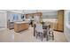 Bright kitchen featuring stainless steel appliances, modern light wood cabinets, and a dining area with comfortable seating at 2321 Terry Ln, Sarasota, FL 34231