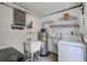 Functional laundry room with sink, water heater, washer, and dryer at 2321 Terry Ln, Sarasota, FL 34231