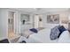 Bright main bedroom with large bed, white dresser, ceiling fan, and neutral decor at 2321 Terry Ln, Sarasota, FL 34231
