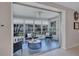 Enclosed sunroom featuring comfortable seating and lots of windows with views of the landscaped yard at 2321 Terry Ln, Sarasota, FL 34231