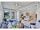 Relaxing sunroom with comfortable seating and a view of the main living area through sliding glass doors at 2321 Terry Ln, Sarasota, FL 34231