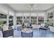 Cozy sunroom featuring comfortable seating, natural light, and a peaceful ambiance overlooking the yard at 2321 Terry Ln, Sarasota, FL 34231