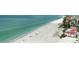 Picturesque beachfront view of ocean meeting the white sandy shore, with nearby residences visible at 2601 Gulf N Dr # 427, Bradenton Beach, FL 34217