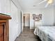 Bright bedroom with an open ensuite bathroom and neutral paint that pairs perfectly with the wood floors at 2601 Gulf N Dr # 427, Bradenton Beach, FL 34217