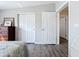 Bright bedroom with 2 closets and an open ensuite bathroom featuring neutral paint and wood-look flooring at 2601 Gulf N Dr # 427, Bradenton Beach, FL 34217
