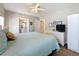 Comfortable bedroom with dresser, TV, and soft blue bedding at 2601 Gulf N Dr # 427, Bradenton Beach, FL 34217