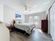 This is a charming bedroom with a ceiling fan and warm natural light streaming through the bright windows at 2601 Gulf N Dr # 427, Bradenton Beach, FL 34217