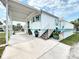 Charming coastal home with a covered carport, stairs leading to the front porch at 2601 Gulf N Dr # 427, Bradenton Beach, FL 34217