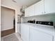 This is a practical laundry room with modern appliances and ample cabinet space at 2601 Gulf N Dr # 427, Bradenton Beach, FL 34217
