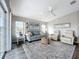 Bright living room with comfortable seating, ceiling fan, and neutral color palette at 2601 Gulf N Dr # 427, Bradenton Beach, FL 34217