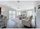Cozy living room boasts stylish furniture, hardwood floors, and plenty of natural light at 2601 Gulf N Dr # 427, Bradenton Beach, FL 34217