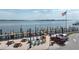 Charming waterfront with colorful Adirondack chairs, picnic tables, and a dock for easy access to the water at 2601 Gulf N Dr # 427, Bradenton Beach, FL 34217