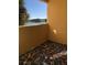 Balcony features unique mosaic tile flooring and a lake view at 2950 Viscaya Pl # 205, Sarasota, FL 34237