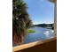 Balcony view of a lake with a fountain and palm trees at 2950 Viscaya Pl # 205, Sarasota, FL 34237