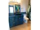 Charming bathroom featuring an artistic blue vanity with a dark stone vessel sink at 2950 Viscaya Pl # 205, Sarasota, FL 34237
