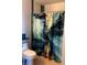 Cozy bathroom featuring a toilet and a shower curtain with blue and white abstract designs at 2950 Viscaya Pl # 205, Sarasota, FL 34237
