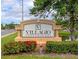 Villagio Condominium community sign with colorful flowers and greenery at 2950 Viscaya Pl # 205, Sarasota, FL 34237