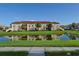 Waterfront condo building with lush landscaping and reflection on water at 2950 Viscaya Pl # 205, Sarasota, FL 34237