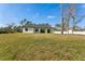 Well-maintained backyard with ample space, mature trees, and privacy fence at 3598 Trinity St, North Port, FL 34291