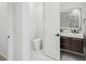 Modern bathroom with dual sink vanity, wood cabinets, and LED mirror at 3598 Trinity St, North Port, FL 34291